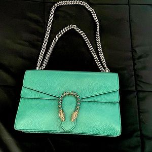 The Dionysus shoulder bag is presented in a vivid shade of green leather.